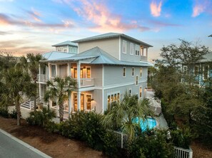 A two-story house with a balcony, a swimming pool, and a view of the surrounding landscape. - STEPS to Seacrest Restaurants, Shops, & More! Private Pool & Bikes! (Seacrest)