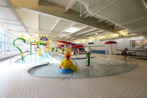 Kids can splash and play in this water play area featuring water slides and play structures.
