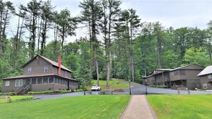 A lodge with a central road, surrounded by dense forest. - Waterfront cottages near lake george and saratoga springs (Lake Luzerne)