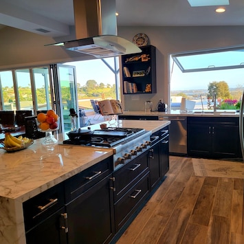 Kitchen island, note cafe window that opens over the sink to the patio