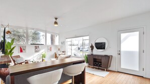 A modern kitchen with a bar area, large windows, and a view of the outside. - ICONIC MID-CENTURY MODERN  “HAVER HOME” (Scottsdale)