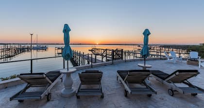 Waterfront home with dock, heated pool, & spectacular views- walk/bike downtown!