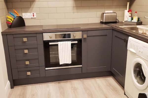 Kitchen showing stove and washer.