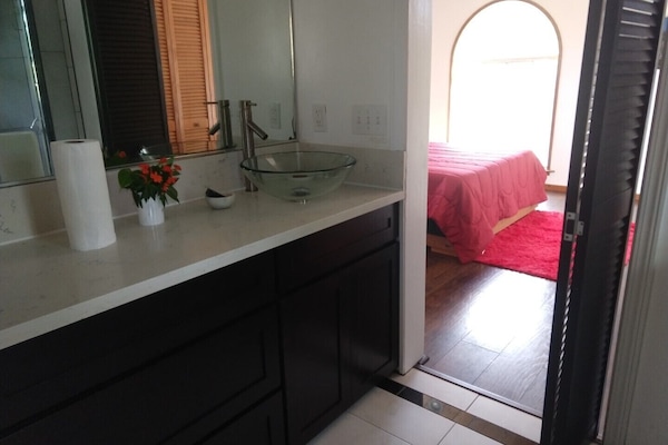 One side of upper suite private bath. Opposite side has walk-in shower.