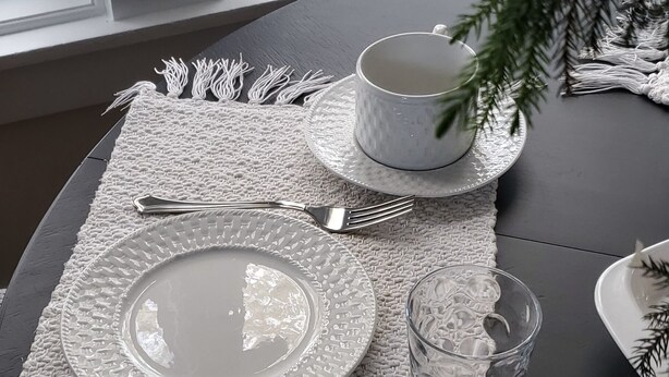 A table set with a white placemat, a white plate, a glass, a fork, and a spoon. - Historic ranch house has beautiful mountain and valley views. Weekly discounts. (Manhattan)