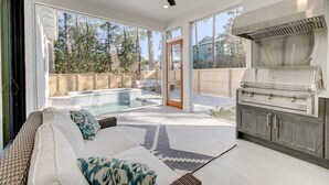 A modern outdoor living area with a pool, a barbecue grill, and a comfortable seating area. - Luxurious 4-BR Home w/ Private Pool & Beach Access – Golf Cart & Bikes Included (Santa Rosa Beach)