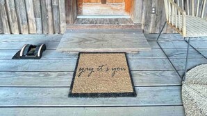 A wooden door with a doormat that reads "yay it's you." - Small cabin on private 400 acre mountaintop farm! (Hinton)
