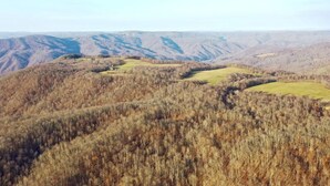 A mountainous landscape with rolling hills and a clear sky. - Small cabin on private 400 acre mountaintop farm! (Hinton)