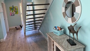 A wooden staircase with a blue wall and a round mirror on the wall. - Waterfront condo located in the waterfront paradise of Bokeelia (Bokeelia)