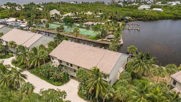 A resort with multiple buildings, a swimming pool, and a dock by the water. - Waterfront condo located in the waterfront paradise of Bokeelia (Bokeelia)