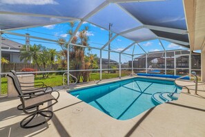 Relax by the pool surrounded by lush greenery and scenic views.