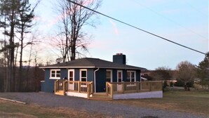 A single-story house with a front porch, a chimney, and a fenced yard. - Mountain Views, River fun, Hiking, Biking, Breweries, Golf, and Wineries galore (Jonesville)