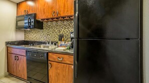 Kitchen equipped with a refrigerator, sink, microwave, and dishwasher.