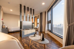 Premium Family Suite | Living area | 50-inch flat-screen TV with cable channels, TV, heated floors