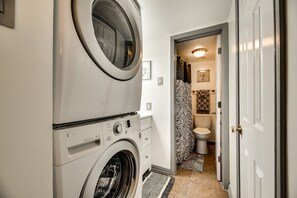 Bathtub, towels, soap, toilet paper