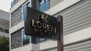A hotel sign with the name "LOREM HOTEL" in large, reflective letters.