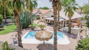 A pool surrounded by palm trees, a covered patio, and a house with a tiled roof. - ☀️🌵Tropical Desert Oasis. HEATED Pool & Spa no charge. Private, large yard 🌴🏜 (Glendale)