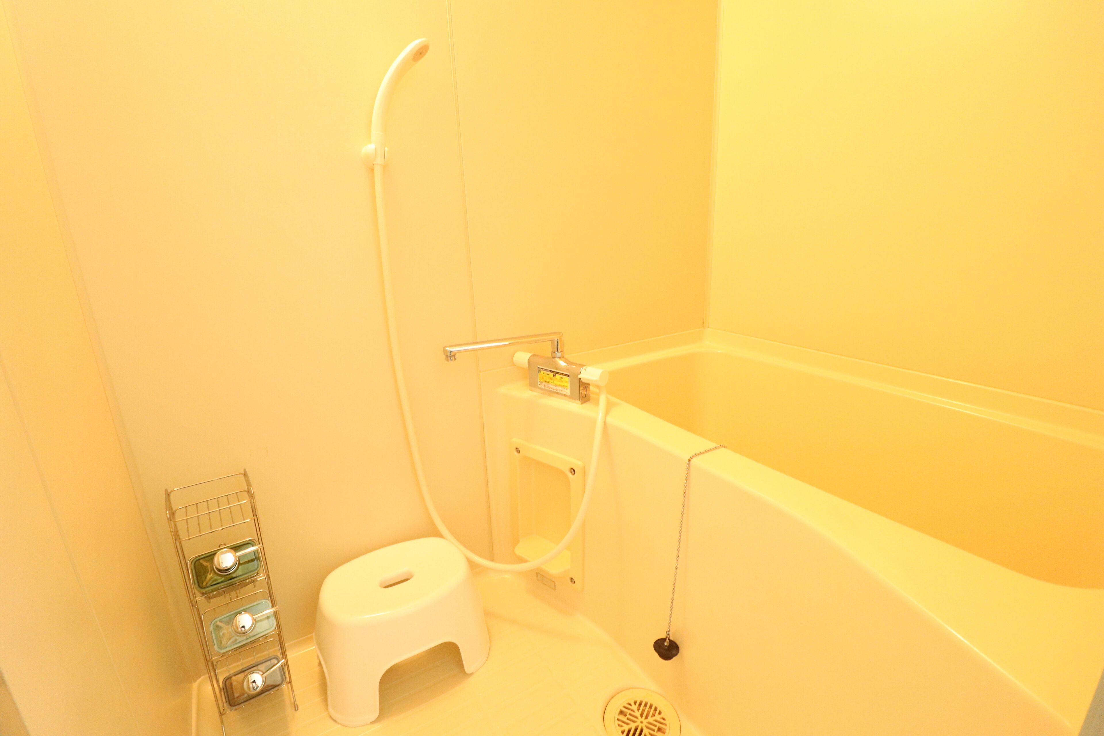 A bathroom with a bathtub, a toilet, and a shower.