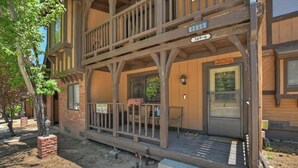 A wooden building with a porch, a welcome sign, and a mailbox. - Summit Adventure Condo by Destination Big Bear: Steps from Snow Summit Resort! Multiple Balconies! (Big Bear Lake)