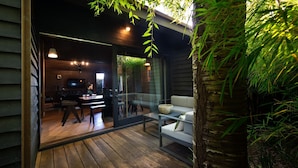 A modern interior with a dining area, a sofa, and a television.