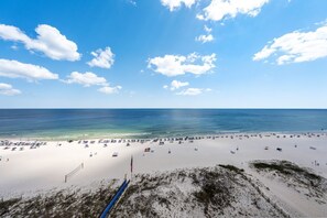 A beach with a clear sky, a sandy shore, and a blue ocean. - Updated Luxury Beachfront Condo w/ Pool, Sauna, & Fitness Center | Sleeps 8 (Gulf Shores)