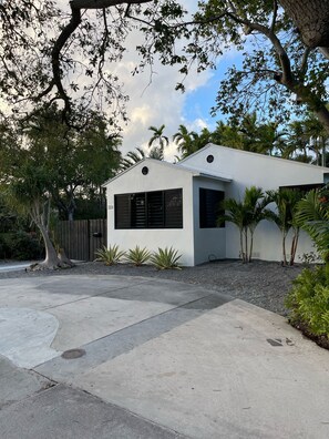 A modern house with a white exterior, a garage, and a driveway.