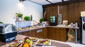 A breakfast buffet with various food items and a coffee station.