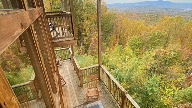 A wooden deck with a view of a forest and mountains. - Gatlinburg Luxury Cabin, 4 Master Bdrms, Theater, Game Rm, Hot Tub, Perfect! (Sevierville)