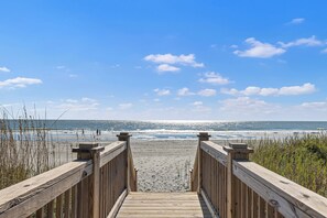 A wooden boardwalk leading to a beach with a clear sky and ocean view. - Beachfront House - Dogs OK - Pool, Near Golf (Murrells Inlet)