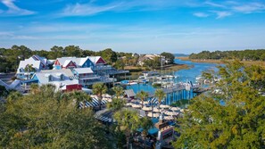 Experience the vibrant coastal town's marina, featuring colorful buildings, docks, and scenic waterfront views.