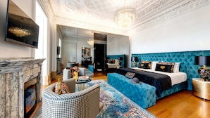 A luxurious bedroom with a large bed, a fireplace, and a chandelier. - 1877 Estrela Palace Hotel (Aveiro)
