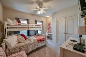 A bedroom with bunk beds, a desk, a chair, and a ceiling fan. - Welcome to Rising Tide! (Tuscaloosa)