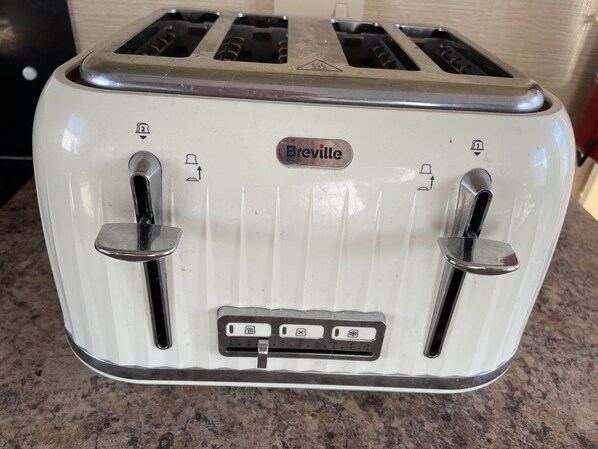 A Breville toaster with two slots, a control panel with buttons, and a brand name. - Escape Rio1 Caravan Seasalter Beach Outdoor Pool (Whitstable)