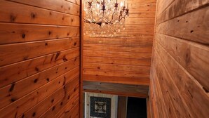 A wooden staircase with a chandelier. - Your private fishing oasis in Big Sandy  (Big Sandy)