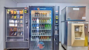 A row of vending machines including a Royal Crown Cola machine, a push vending machine, and an Ice Cubes machine. - Studio 6 Effingham, Il (Effingham)