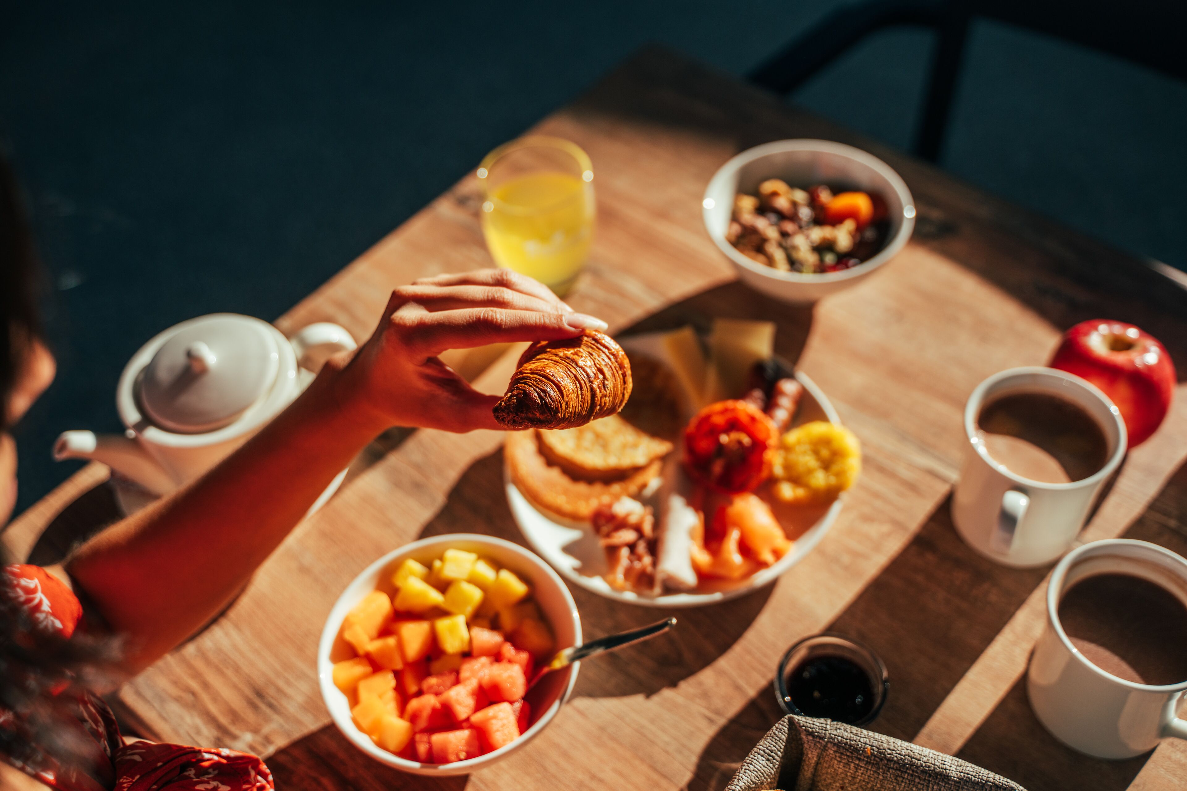 Une table de petit-déjeuner avec divers aliments et boissons.