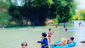 A river with people swimming and floating. - Son's Blue River Camp - Glamping Cabin #1 (Kingsbury)