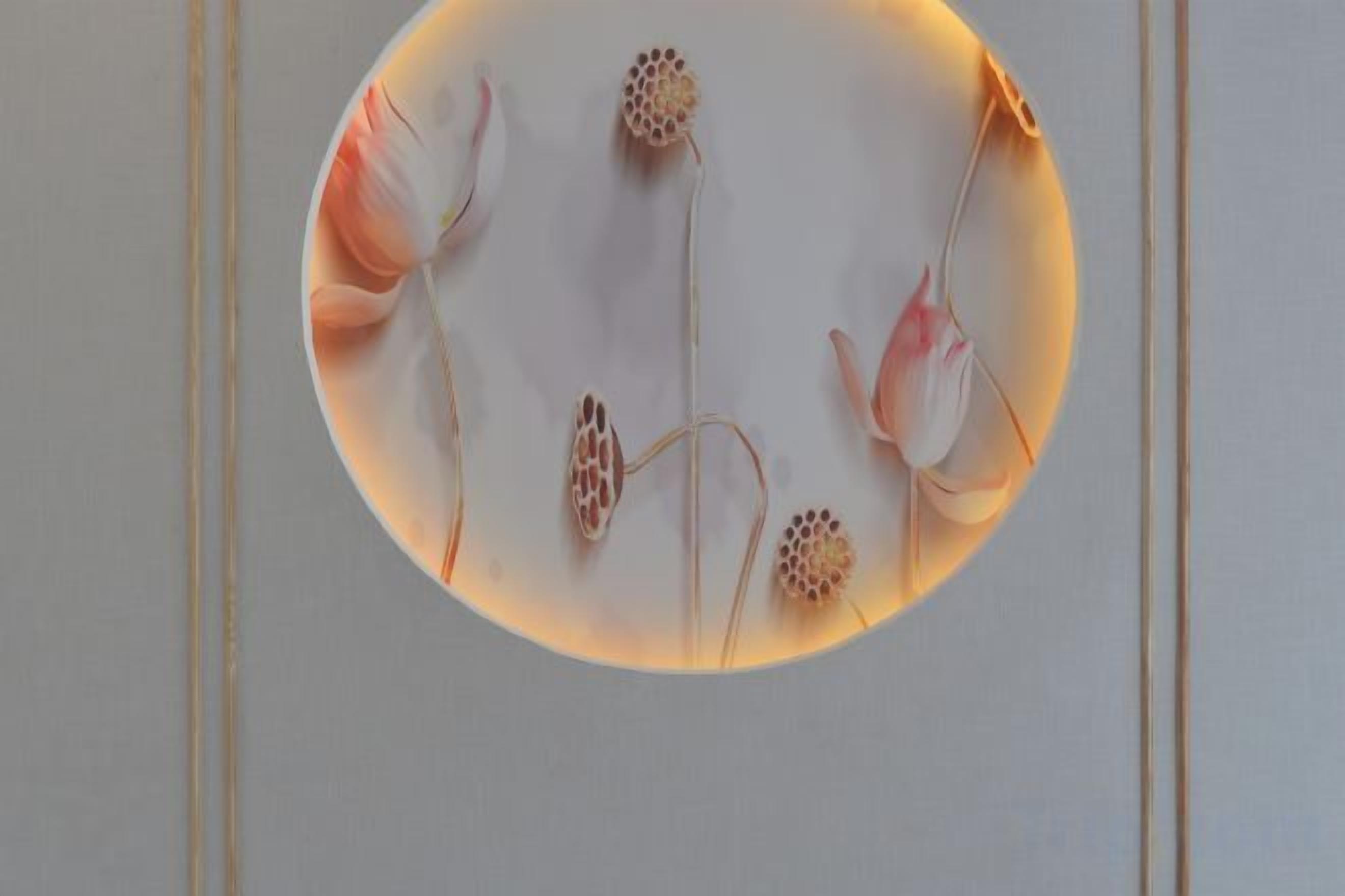 A circular light fixture with a floral design.