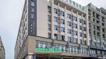 A multi-story hotel building with a prominent sign for a business hotel.
