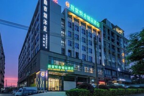 A multi-story hotel with a prominent sign indicating it is a hotel. - HTYS Boutique Hotel (Dongguan)