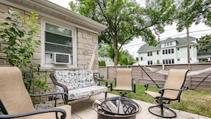 A patio with outdoor furniture, a fire pit, and a house in the background. - Central Tosa home near downtown, state fair, froedtert (Wauwatosa)