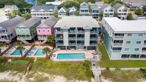 A coastal hotel with multiple floors, a swimming pool, and beach access. - Oceanfront Getaway,  Directly on the Beach with Amazing Views (Surfside Beach)