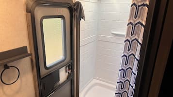 Shower, hair dryer, towels, toilet paper