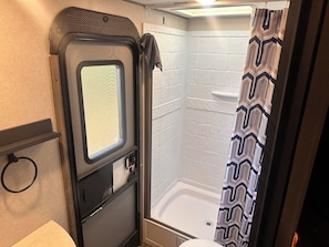 Shower, hair dryer, towels, toilet paper