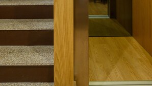 An elevator with a wooden interior, a digital display, and a chair. - Northern Star - Apartment 2.0 Porto (in the city center) (Porto)