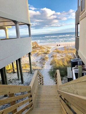 A wooden staircase leading to a sandy beach area with a view of the ocean. - Clean & Ready for Guests! Recently Remodeled, Steps to the Beach! (Miramar Beach)