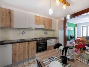 Fridge, oven, cookware/dishes/utensils, dining tables