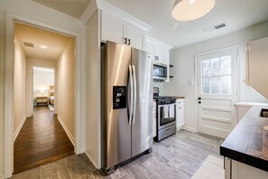 A modern kitchen with stainless steel appliances, a microwave, and a stove.