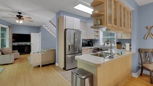 A modern kitchen with a central island, stainless steel appliances, and wooden cabinetry. - Lake Hartwell Retreat, Clemson Football Weekends, 4BR + Private Dock (Westminster)