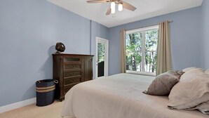 A bedroom with a bed, a ceiling fan, a dresser, a window, and a door. - Lake Hartwell Retreat, Clemson Football Weekends, 4BR + Private Dock (Westminster)